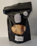 Black bag of freeze dried cantaloupe on a white surface