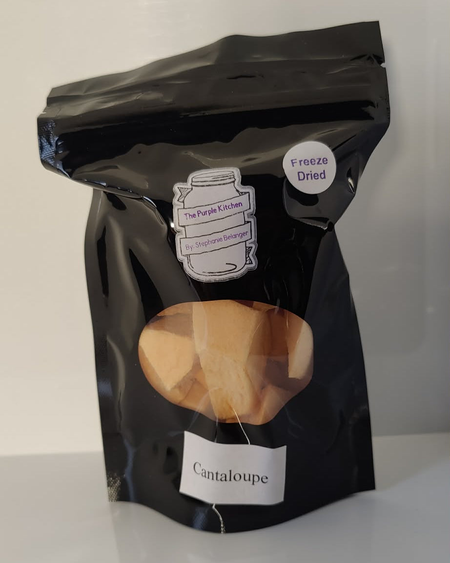 Black bag of freeze dried cantaloupe on a white surface