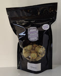 Black packaging of freeze dried grapes on a white surface