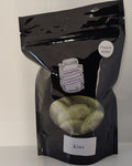 Black package of freeze dried kiwi on a white background
