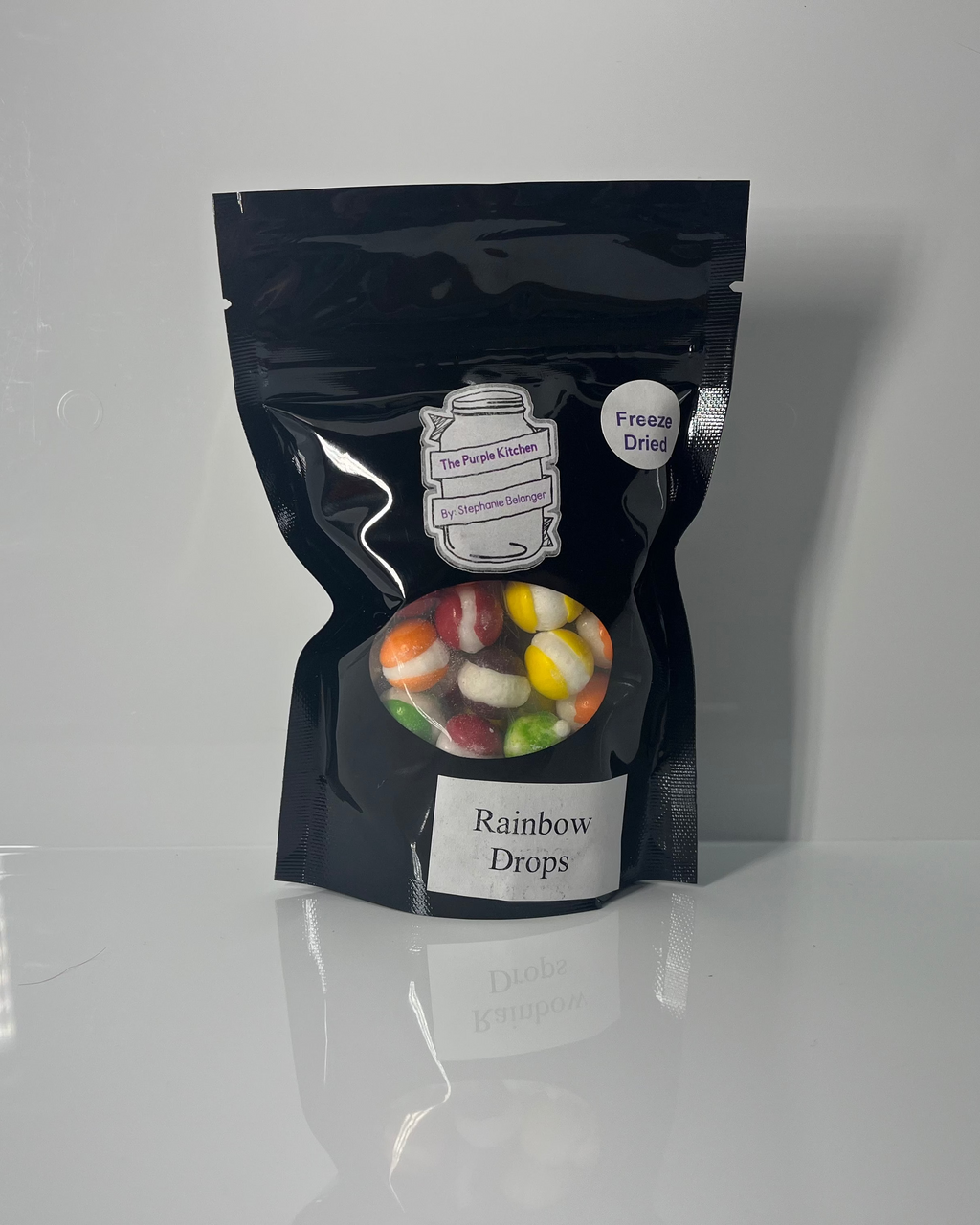 Black package of 'Rainbows Drops' on a white background
