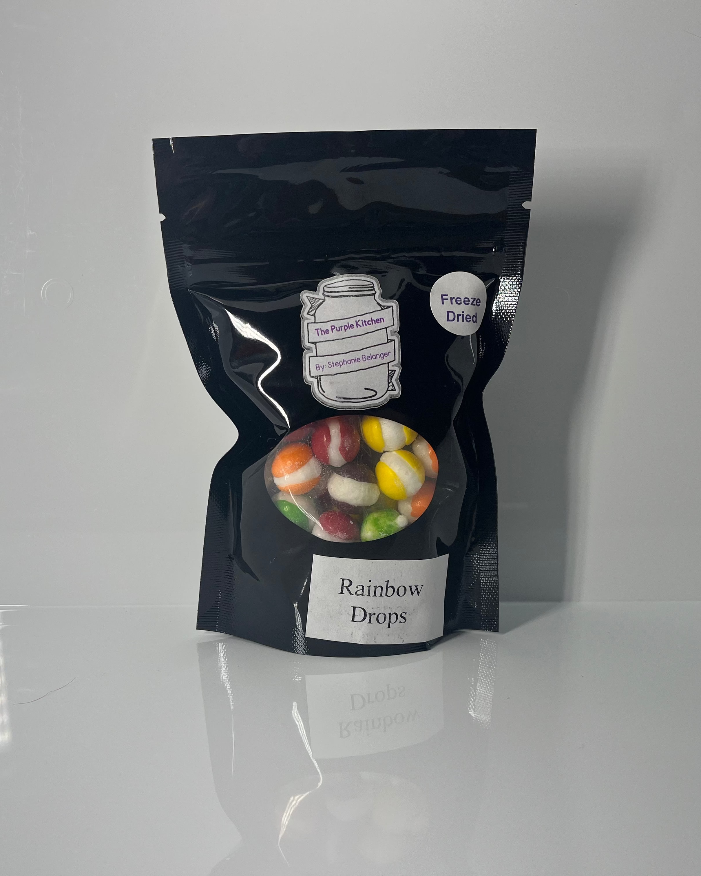 Black package of 'Rainbows Drops' on a white background
