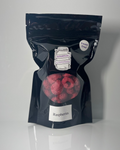 Black package of freeze dried raspberries on a white background
