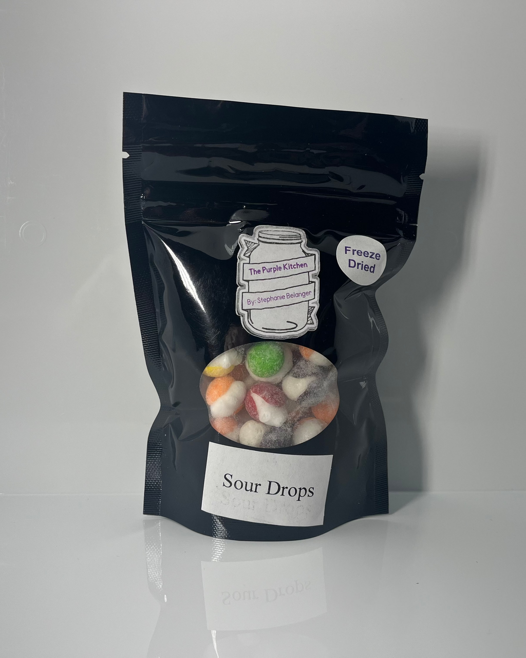 Black ziplock bag with 'Sour Drops' label on a white background