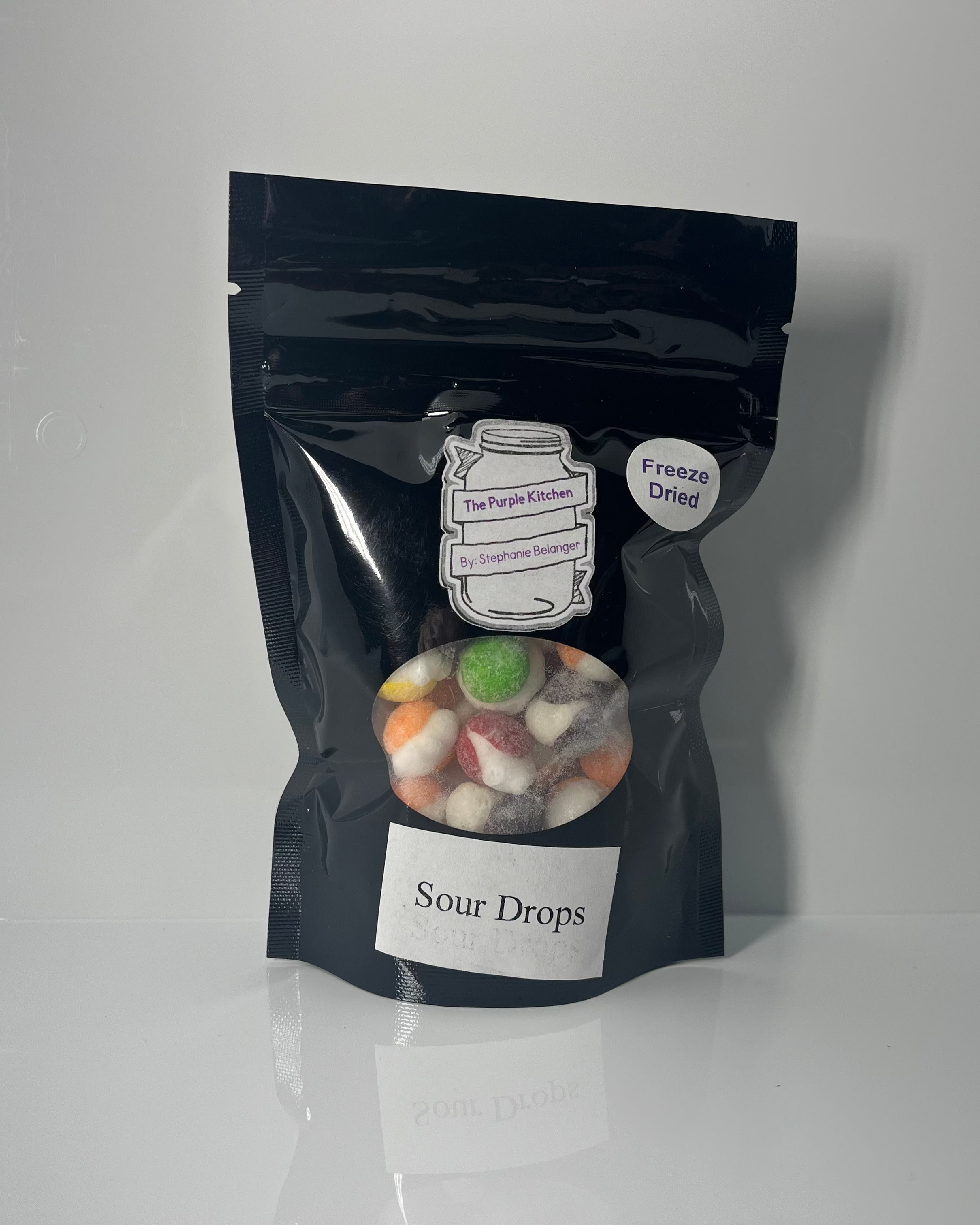 Black ziplock bag with 'Sour Drops' label on a white background